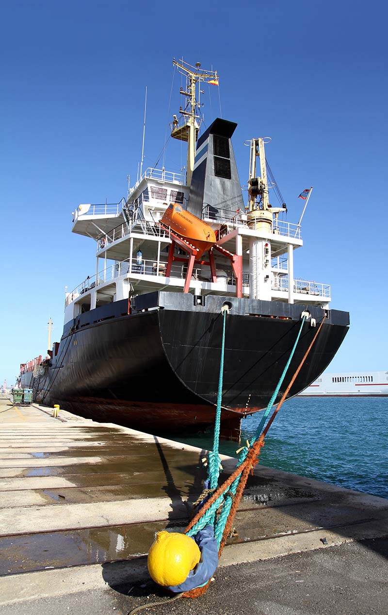 18563677 - cargo ship in port view of the stern